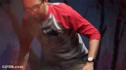 Man In Batman Shirt Stretching Legs GIF