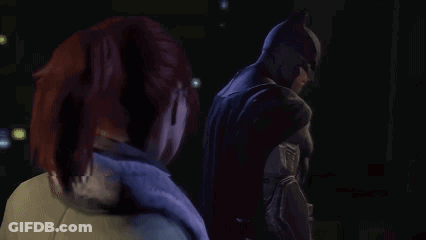 Man In Batman Suit Beside Woman In Dark Room GIF