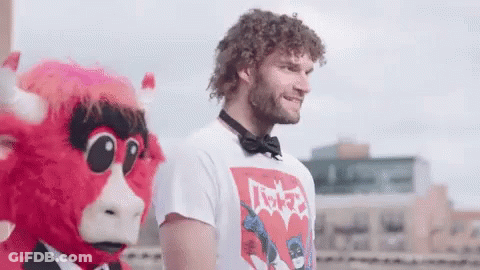 Man In Batman T-Shirt Next To Red Bull Mascot GIF