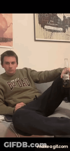 Man In Be Dad Sweater Holding Corona GIF