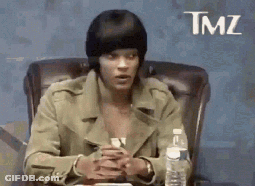 Man In Beanie And Jacket Sitting At Table GIF