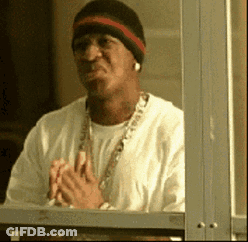 Man In Beanie And Necklace Looking Out Window GIF