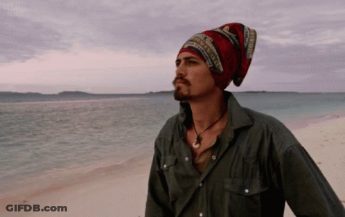 Man In Beanie And Necklace On Beach GIF
