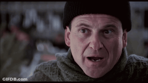 Man In Beanie And Sweater Looking At Camera GIF