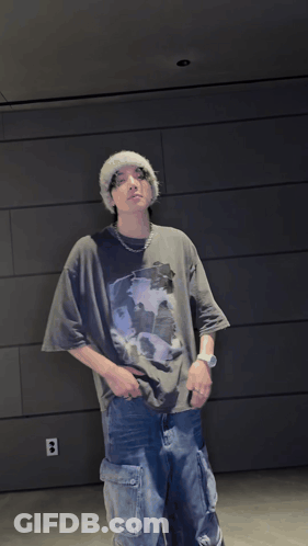 Man In Beanie And T-Shirt With Hands On Hips GIF