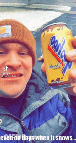 Man In Beanie Holding Cookies N Cream Can GIF