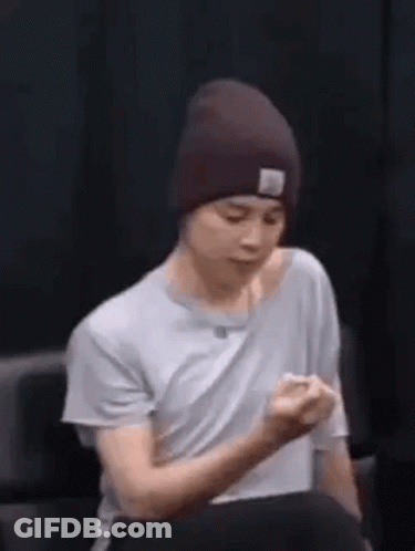 Man In Beanie Holding Fist Up GIF