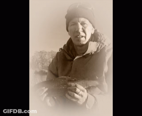 Man In Beanie Holding Large Fish GIF