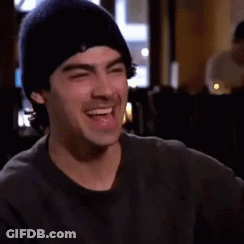 Man In Beanie Laughing With Eyes Closed GIF