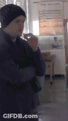 Man In Beanie Standing In Room GIF