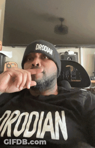 Man In Beanie Wearing Drodilan Shirt GIF