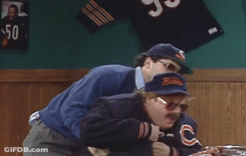 Man In Bear Hat Holding Another Man In Bar GIF