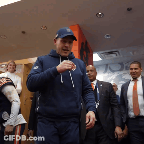 Man In Bear Sweatshirt In Locker Room GIF