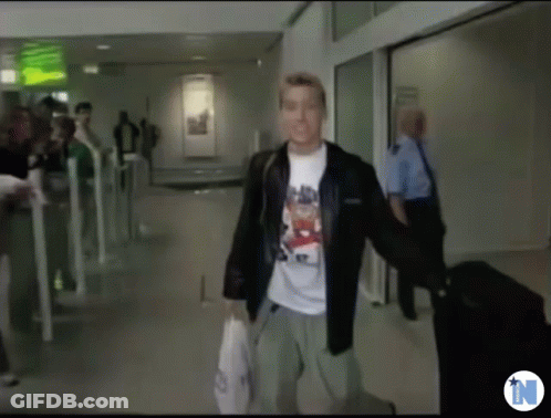 Man In Bear T-Shirt Walking Down Hallway GIF