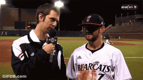 Man In Bearcats Jersey Talks To Another Man GIF