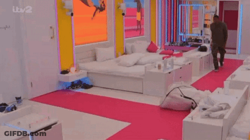 Man In Bedroom With Pink Rug And ITV 2 Screen GIF
