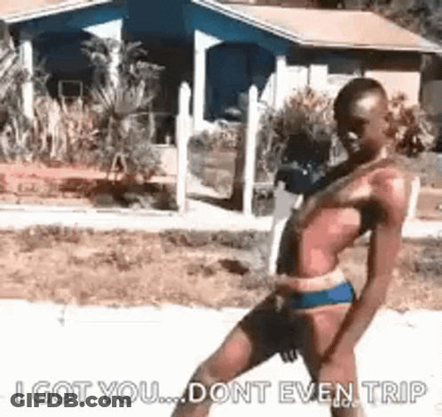 Man In Bikini Walking Down Sidewalk GIF