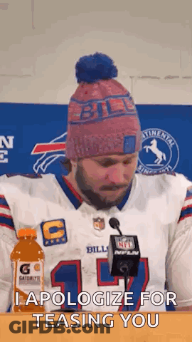 Man In Bills Jersey Sitting At Table With Gatorade And Microphone GIF