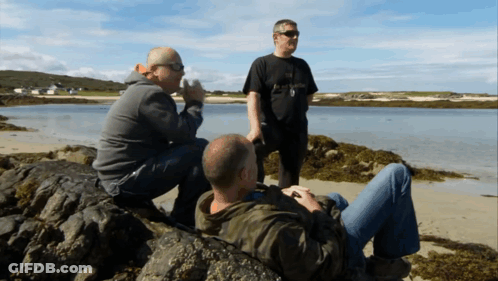 Man In Black Abercrombie & Fitch Shirt Sitting On Rock GIF