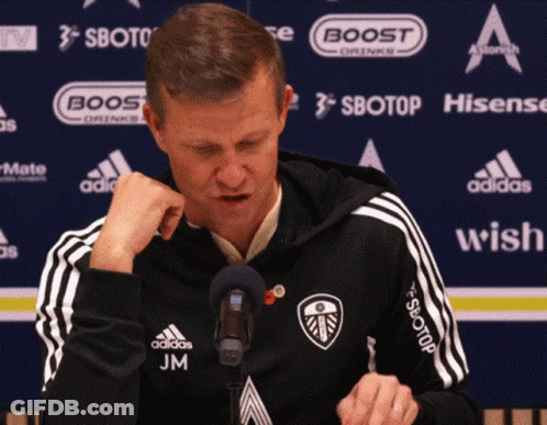Man In Black Adidas Jacket At Microphone With Sponsors GIF