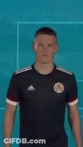 Man In Black Adidas Jersey By Blue Wall GIF