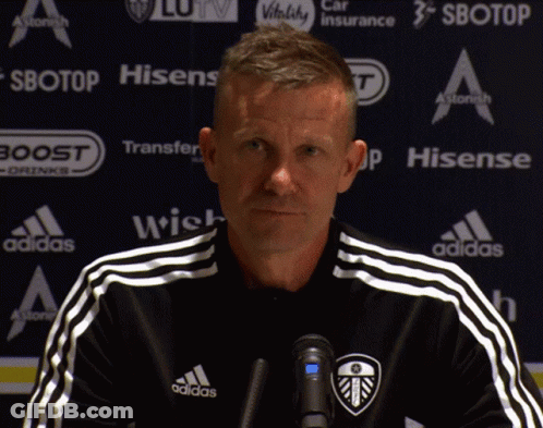 Man In Black Adidas Shirt In Front Of Sbotop Sign GIF