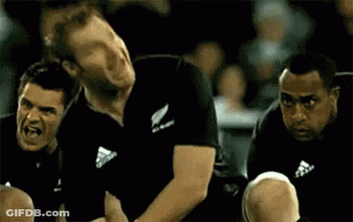 Man In Black Adidas Shirt Sitting Next To Man GIF