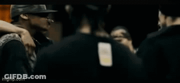 Man In Black Adidas Shirt Talking To Man In Hat GIF