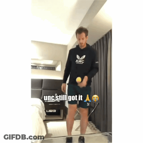 Man In Black AMC Sweatshirt Holding Tennis Ball GIF