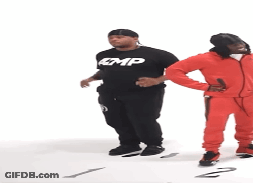 Man In Black Amp Shirt Next To Man In Red Jumpsuit GIF