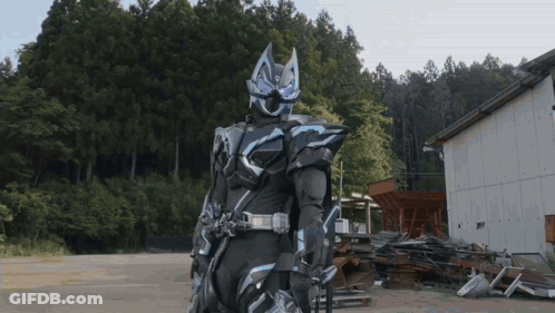 Man In Black And Blue Armor Before Junk Pile GIF