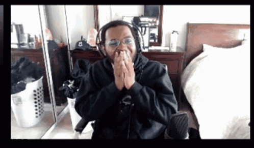 Man In Black And Gold Costume In Front Of White Building GIF