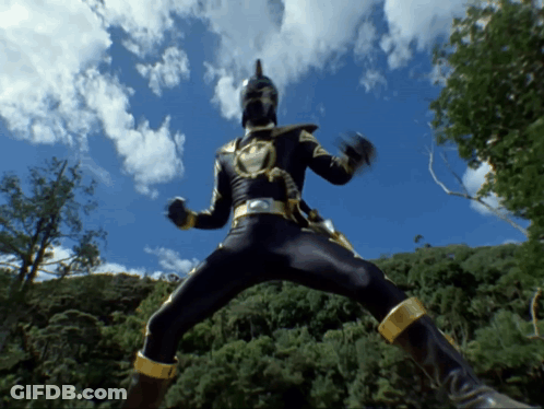 Man In Black And Gold Costume Jumping With Trees GIF