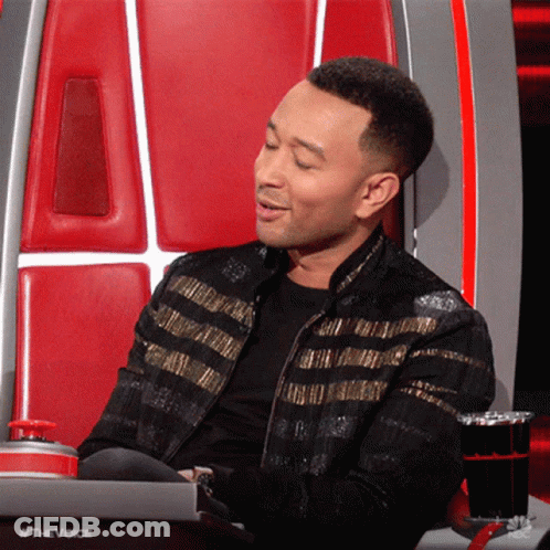 Man In Black And Gold Jacket In The Voice Chair GIF