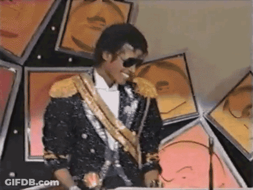 Man In Black And Gold Suit Sunglasses By Picture Wall GIF