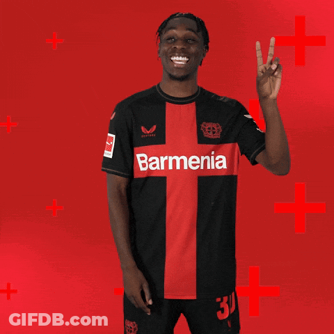Man In Black And Red Barmenia Jersey Giving Peace Sign GIF