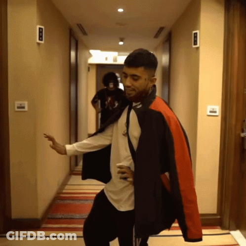 Man In Black And Red Jacket Dancing In Hallway GIF