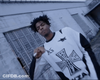 Man In Black And White Cross Shirt Smoking GIF