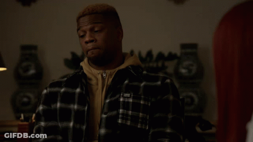 Man In Black And White Plaid Shirt With White Sticker On Sleeve GIF