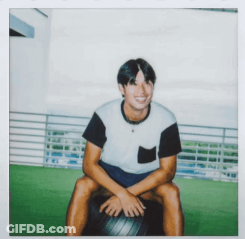 Man In Black And White Shirt Sitting On Black Ball GIF