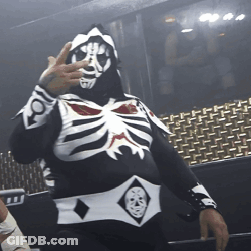 Man In Black And White Skeleton Costume Holding Up Hand GIF
