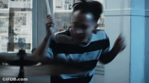 Man In Black And White Striped Shirt Holding Bat GIF