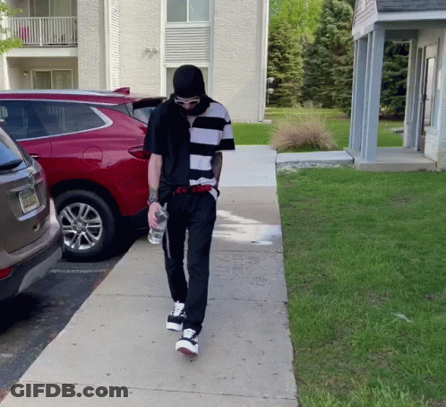 Man In Black And White Striped Shirt Walking GIF