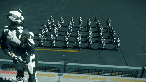 Man In Black And White Suit Before Soldiers In White GIF