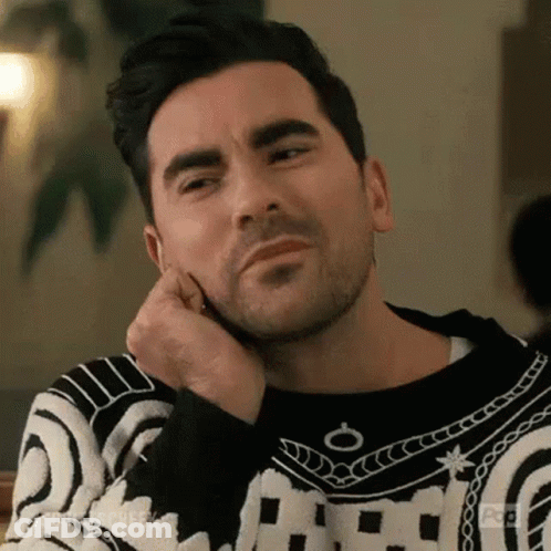 Man In Black And White Sweater Sitting At Table GIF