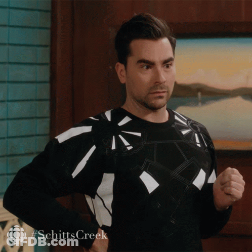 Man In Black And White Sweater With #Schitts Creek GIF