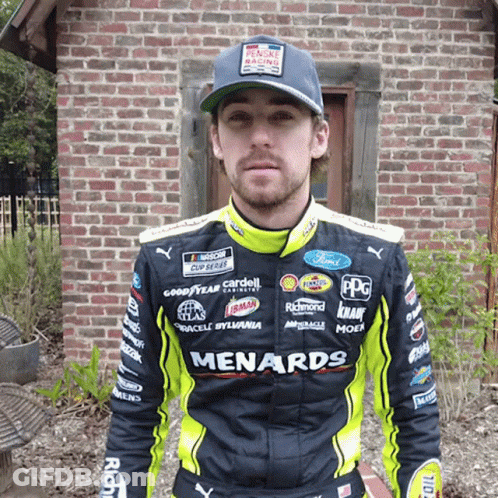 Man In Black And Yellow Menards Jacket By Brick Building GIF