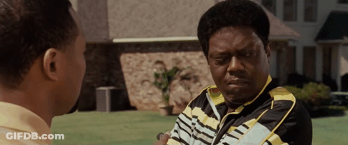 Man In Black And Yellow Talking To Man GIF
