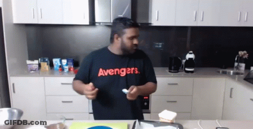 Man In Black Avengers Shirt Holding Spoon GIF