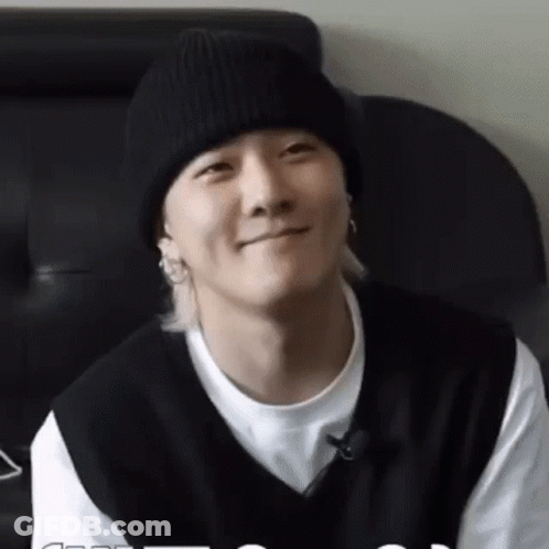 Man In Black Beanie And Black Vest Smiling GIF